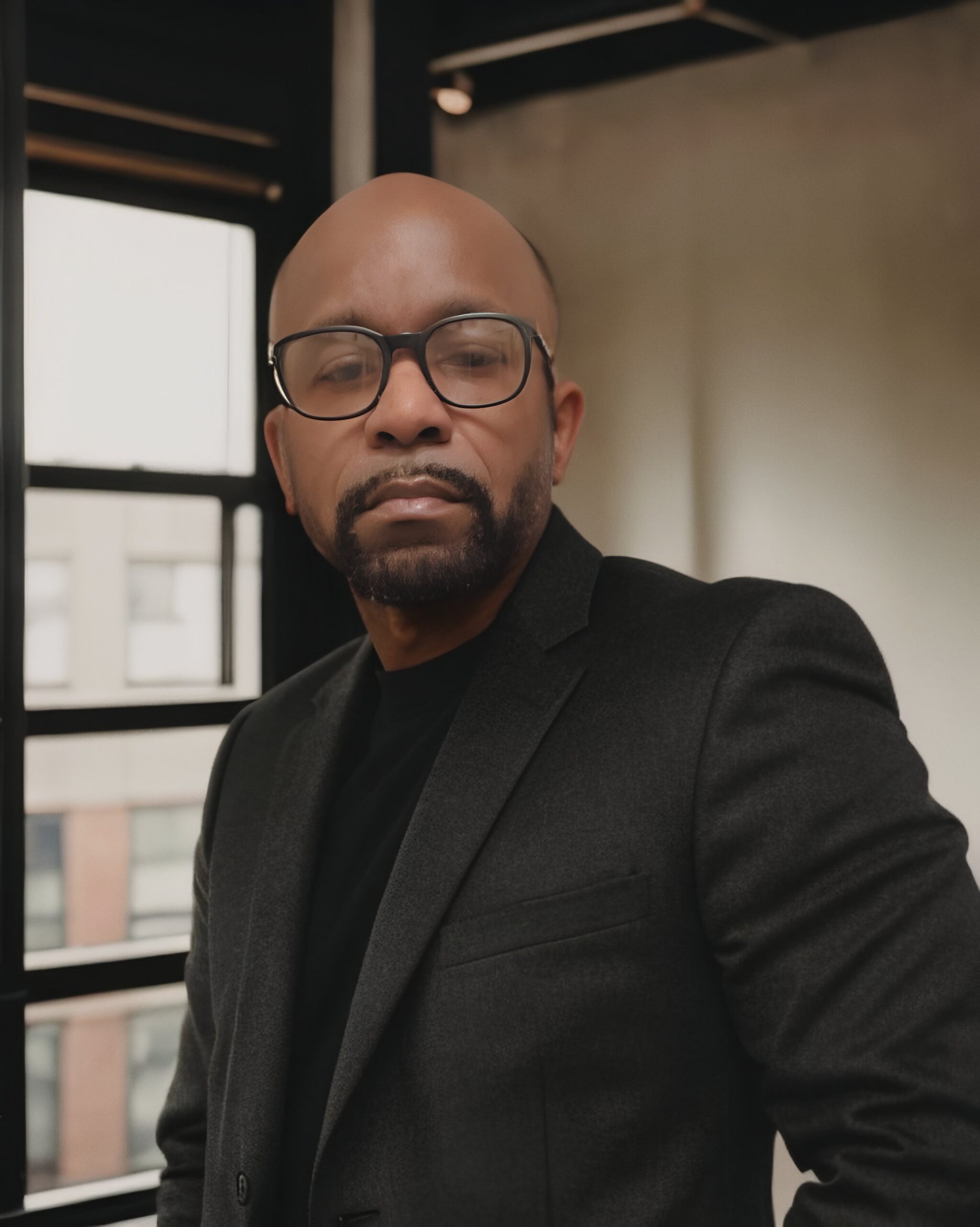Steve Fearon, founder and creative director of Safcom Studio, posing in professional office.